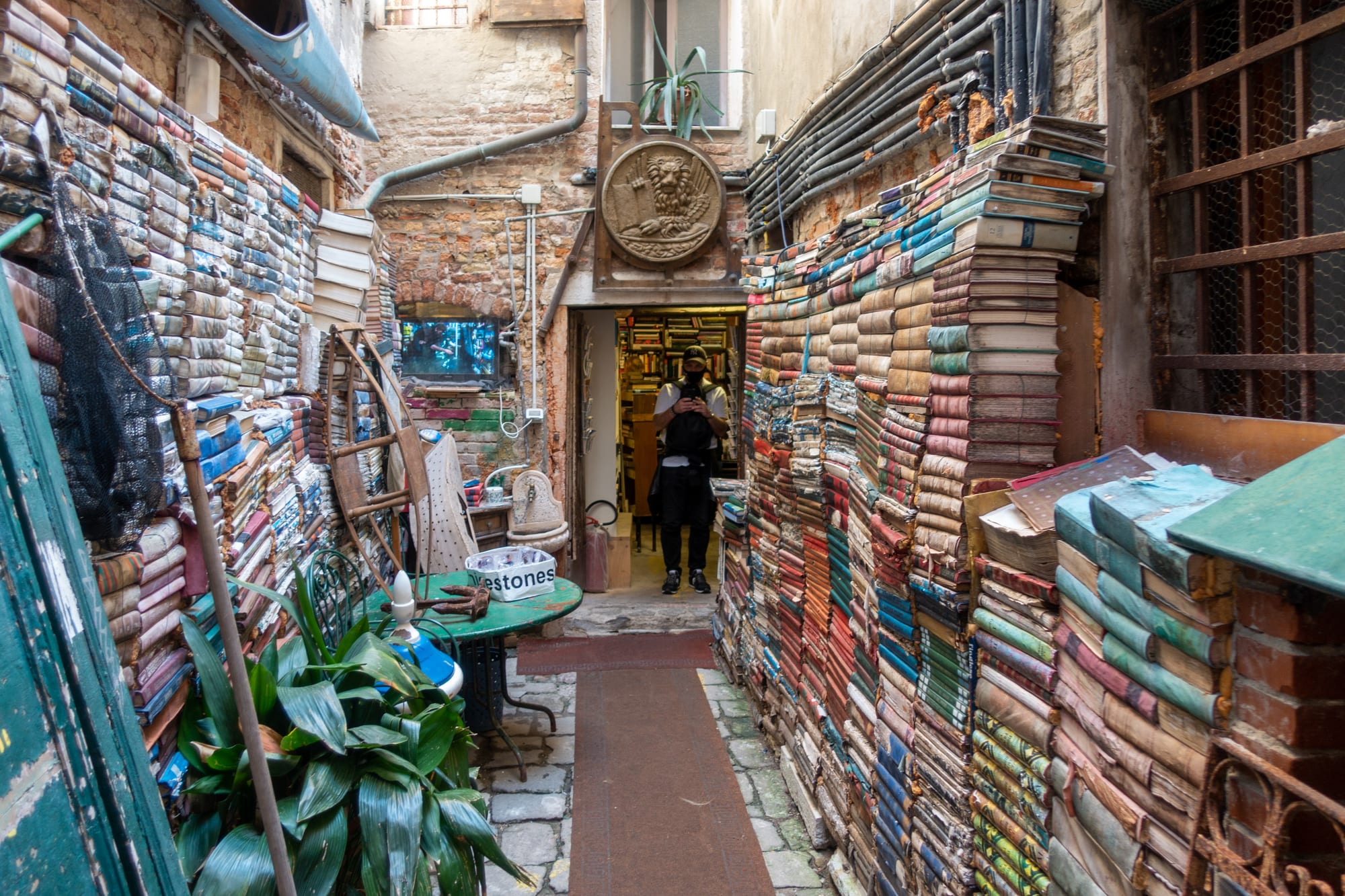 Books stacked in gondolas and boats inside Libreria Acqua Alta in Venice